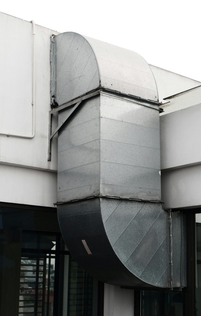 Close-up of a contemporary ventilation duct exterior in a city setting.